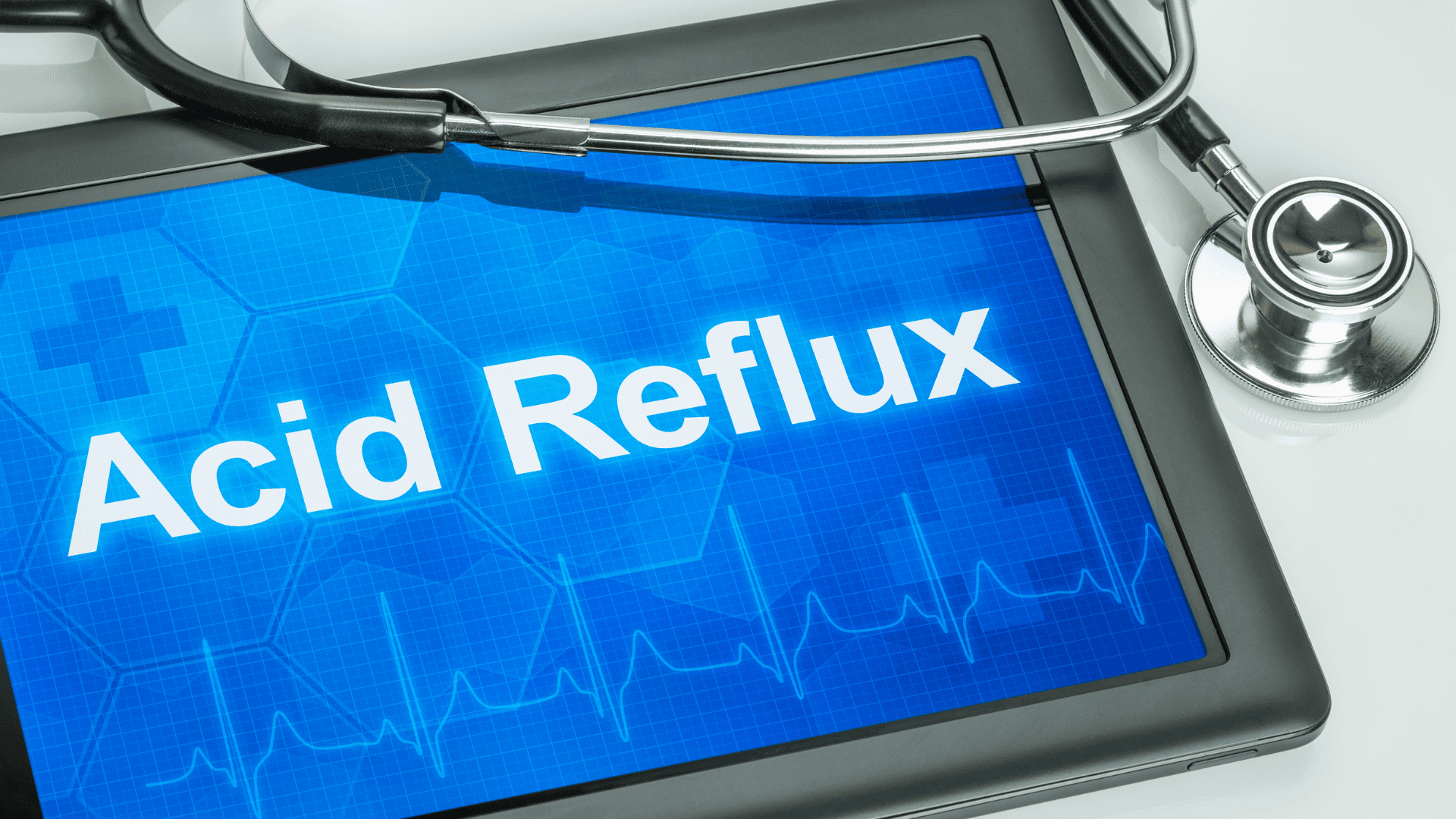 Tablet displaying "Acid Reflux" with a stethoscope, symbolizing functional nutrition strategies for managing GERD and digestive health.